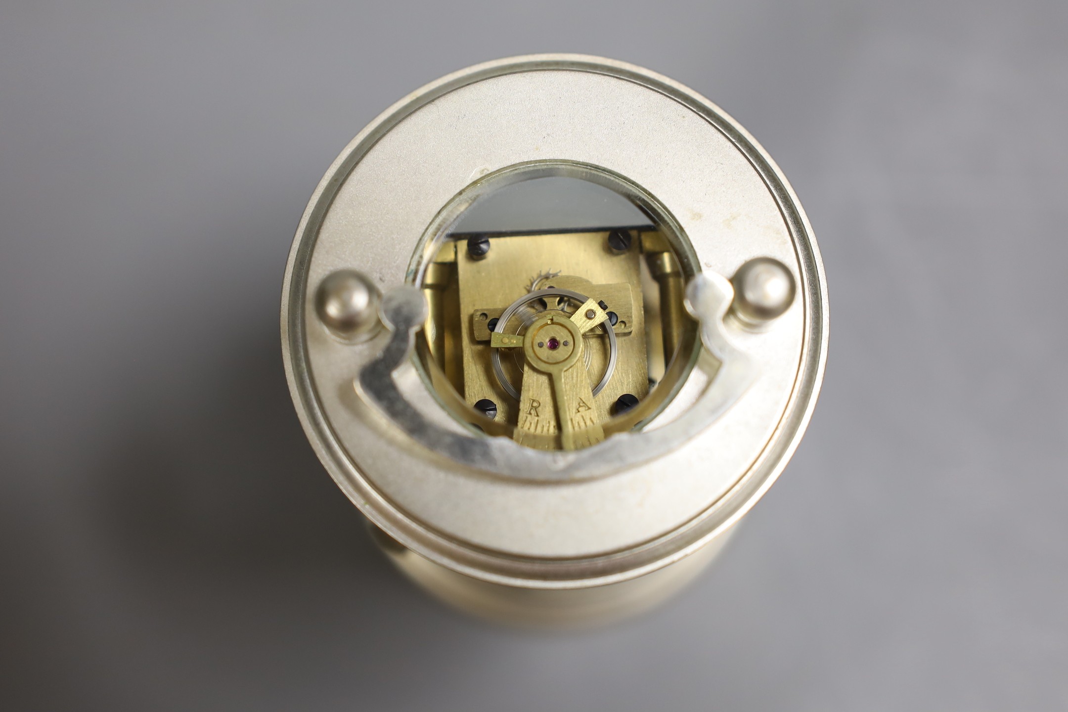 A circular plated carriage clock with key and a Victoria Cross gent's wristwatch